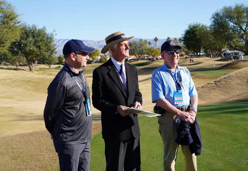 honorary observers standing on golf course