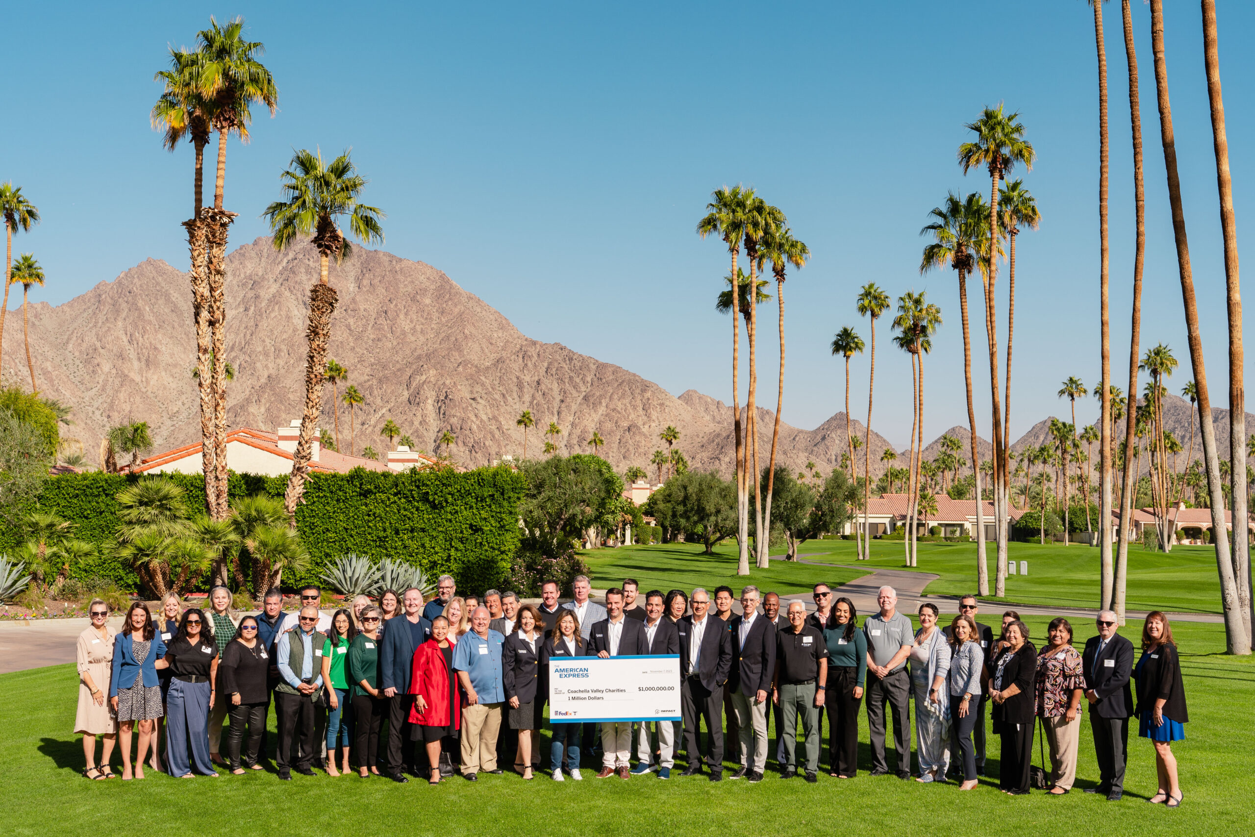 people standing behind charity check and smiling